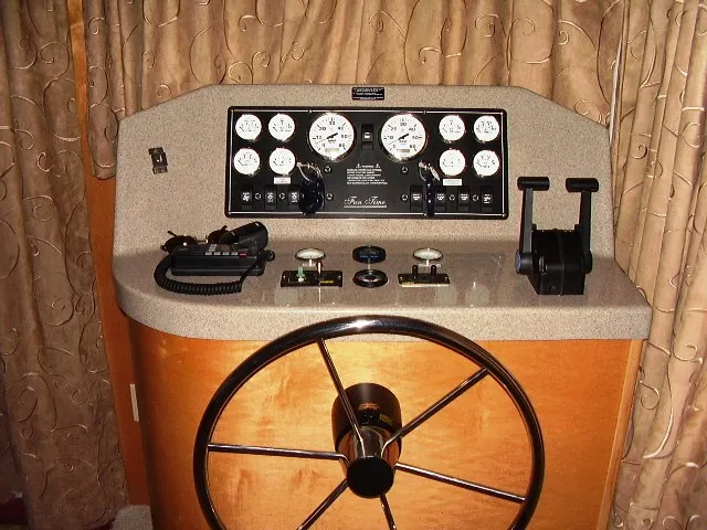 Slide: The Image of Control panel of a 2005 Starlite Multi Owner Houseboat with steering wheel and gauges. - 3