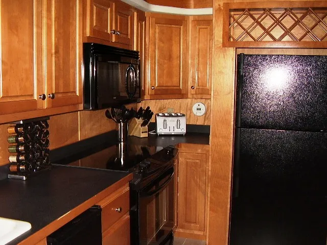 Slide: The Image of Kitchen interior of 2005 Starlite Multi Owner Houseboat with wooden cabinets and modern appliances. - 4