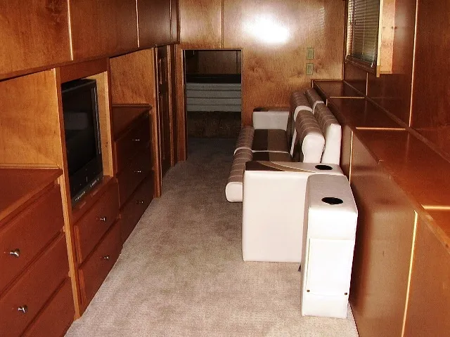 Slide: The Image of Interior of 2005 Starlite Multi Owner Houseboat with wood paneling and white seating. - 8
