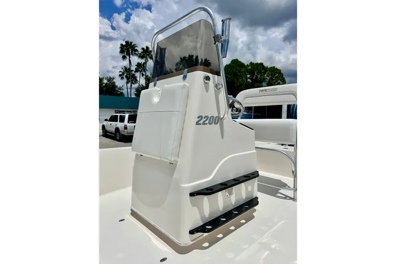 Slide: The Image of 2012 Pathfinder 2200 TRS boat console with clear skies and palm trees in the background. - 13