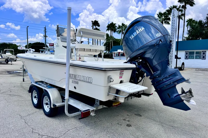 Slide: The Image of 2012 Pathfinder 2200 TRS boat with Yamaha outboard motor on trailer, parked outdoors. - 6