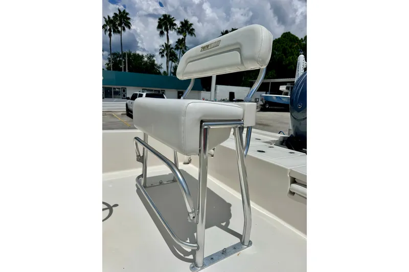 Slide: The Image of White cushioned seat on 2012 Pathfinder 2200 TRS boat, with chrome frame and outdoor setting. - 15