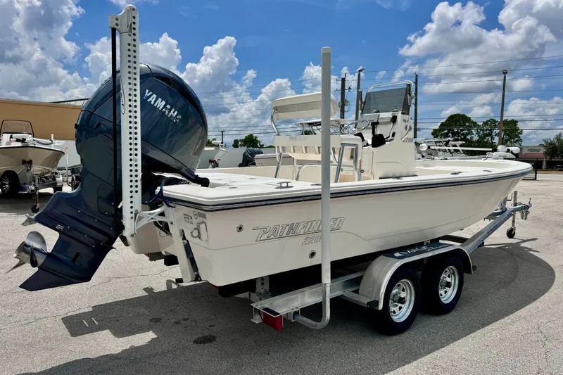 Slide: The Image of 2012 Pathfinder 2200 TRS boat on trailer with Yamaha outboard motor, parked outdoors. - 8