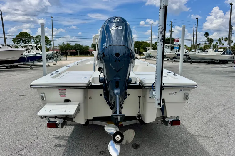 Slide: The Image of 2012 Pathfinder 2200 TRS boat with Yamaha 150 engine, parked outdoors. - 7