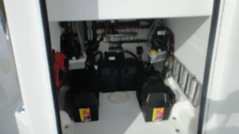 Slide: The Image of 2024 Contender 28T boat battery compartment with wiring and components. - 13
