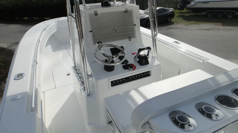 Slide: The Image of 2024 Contender 28T center console boat with steering wheel and control panel. - 18