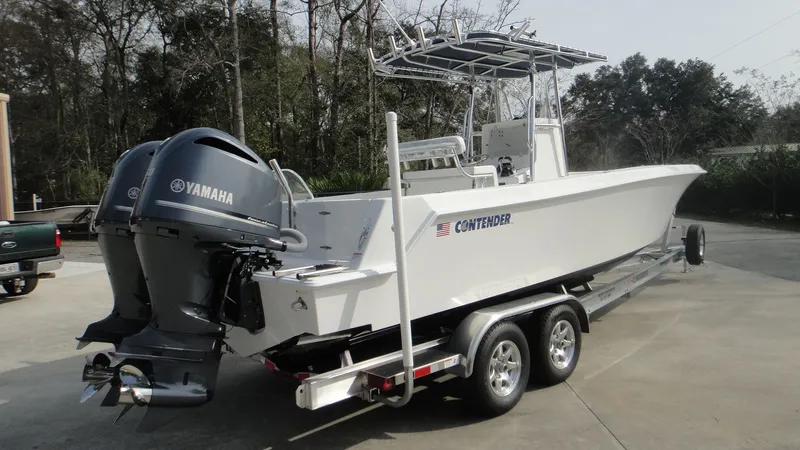 Slide: The Image of 2024 Contender 28T boat on trailer with twin Yamaha engines. - 5