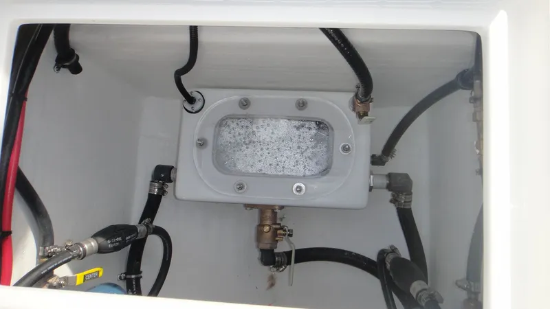 Slide: The Image of Contender 28T 2024 model boat bilge compartment with hoses and fittings. - 10