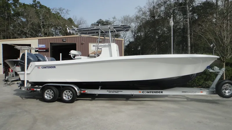 Slide: The Image of 2024 Contender 28T boat on a trailer outside a storage facility. - 3
