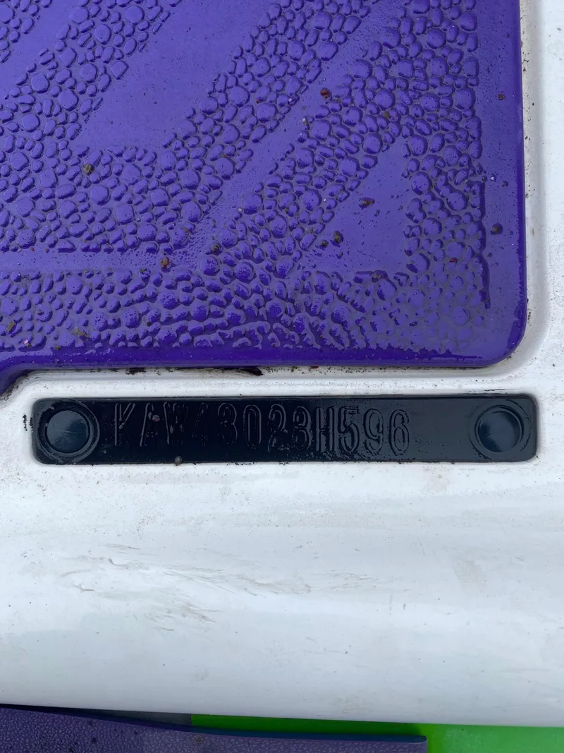 Slide: The Image of 1996 Kawasaki ZXI 900 VIN plate on purple textured surface. - 7