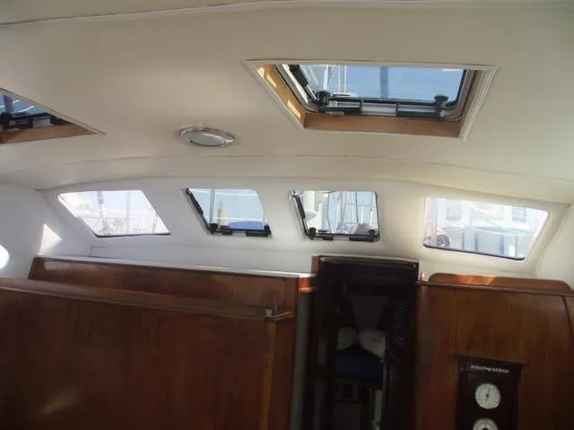 Slide: The Image of Interior of a 1984 Irwin Center Cockpit yacht with windows and wood paneling. - 20