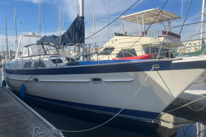Slide: The Image of 1984 Irwin Center Cockpit sailboat docked at marina under clear blue sky. - 36