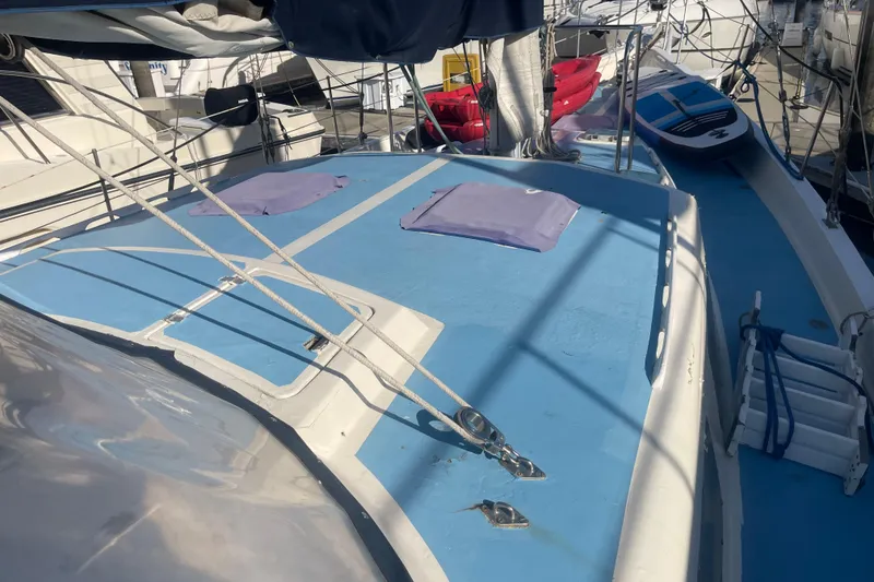 Slide: The Image of 1984 Irwin Center Cockpit sailboat deck with blue surface and docked surroundings. - 39