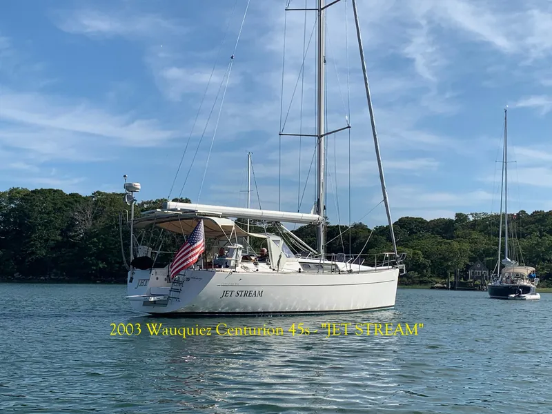 The Image of 2003 Wauquiez Centurion 45s sailboat "Jet Stream" on calm water with trees in background. - 0