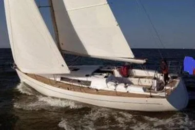 Slide: The Image of 2003 Wauquiez Centurion 45s sailing on open water, white sails unfurled. - 1
