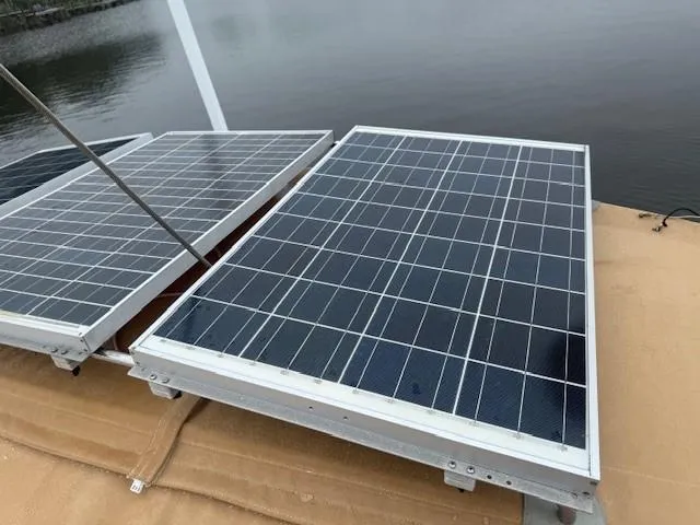 Slide: The Image of Solar panels on a 2003 Wauquiez Centurion 45s yacht by the water. - 14