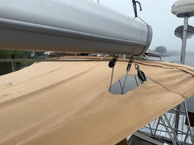 Slide: The Image of Sailboat Wauquiez Centurion 45s, 2003 model, with beige canvas cover and visible rigging. - 15