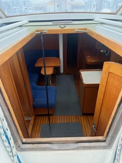 Slide: The Image of Interior view of 2003 Wauquiez Centurion 45s sailboat, featuring wooden furnishings and blue seating. - 22