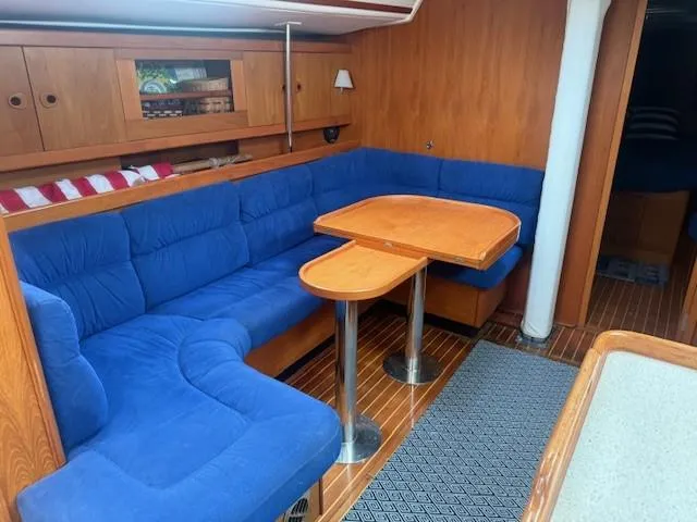 Slide: The Image of Interior of 2003 Wauquiez Centurion 45s yacht with blue seating and wooden table. - 25