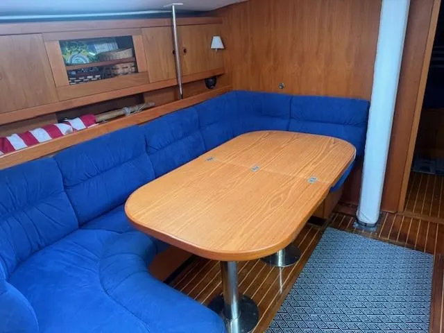 Slide: The Image of Interior of 2003 Wauquiez Centurion 45s yacht with blue seating and wooden table. - 26