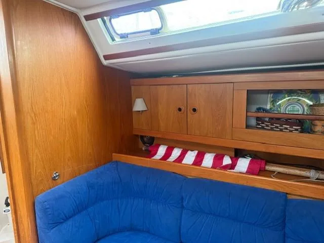 Slide: The Image of Interior of 2003 Wauquiez Centurion 45s yacht with blue seating and wooden cabinets. - 27