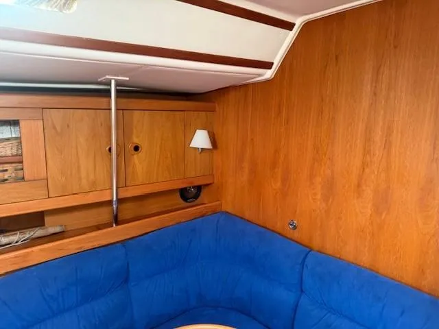 Slide: The Image of Cozy interior of 2003 Wauquiez Centurion 45s sailboat with blue seating and wooden cabinetry. - 28