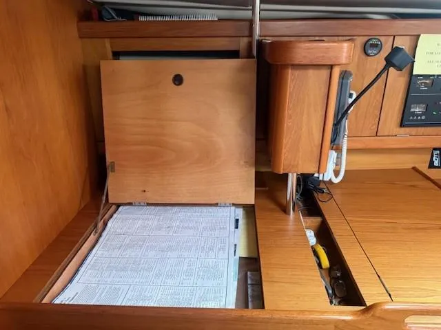 Slide: The Image of Navigation station inside 2003 Wauquiez Centurion 45s yacht with wooden cabinetry and charts. - 30