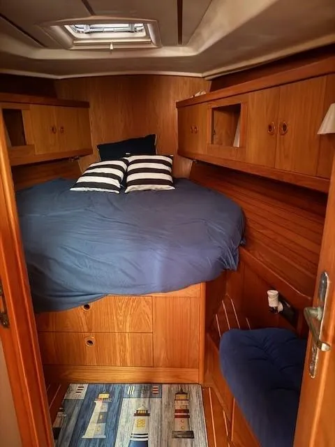 Slide: The Image of Cozy cabin interior of 2003 Wauquiez Centurion 45s sailboat with wood finish and blue bedding. - 38
