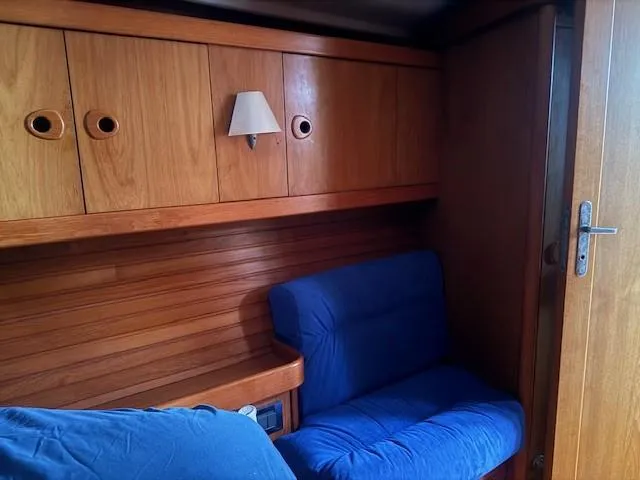 Slide: The Image of Cozy wooden cabin interior with blue seating on a 2003 Wauquiez Centurion 45s yacht. - 39