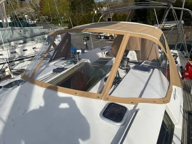 Slide: The Image of 2003 Wauquiez Centurion 45s sailboat with tan cockpit cover, docked in marina. - 4