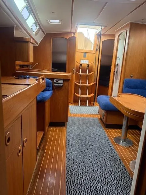 Slide: The Image of Interior of 2003 Wauquiez Centurion 45s yacht with wooden finish and blue seating. - 43