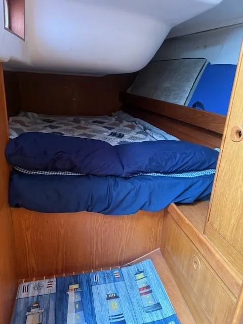 Slide: The Image of Cozy cabin interior of 2003 Wauquiez Centurion 45s sailboat with wooden finish and bedding. - 44