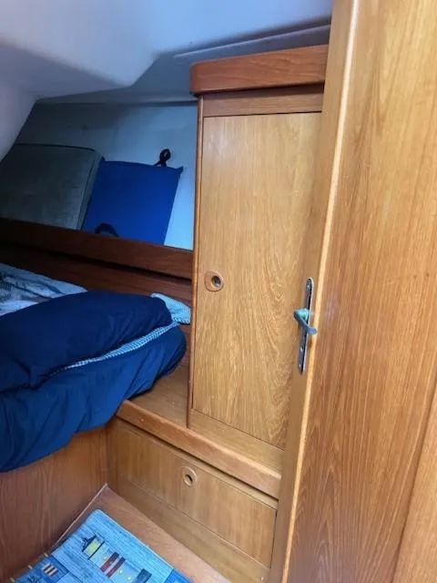 Slide: The Image of Interior of 2003 Wauquiez Centurion 45s yacht with wooden cabinetry and bedding. - 45