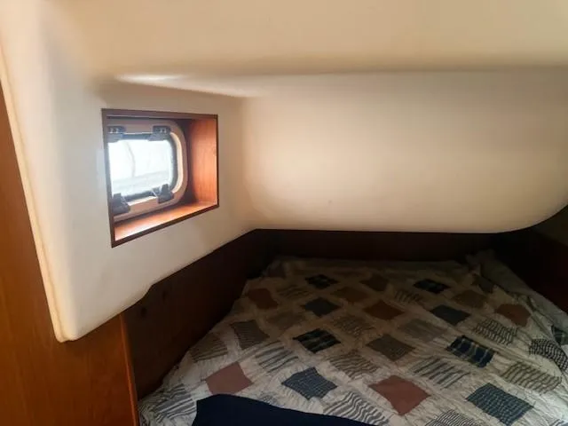 Slide: The Image of Cozy cabin interior of 2003 Wauquiez Centurion 45s sailboat with window and patterned bedding. - 46