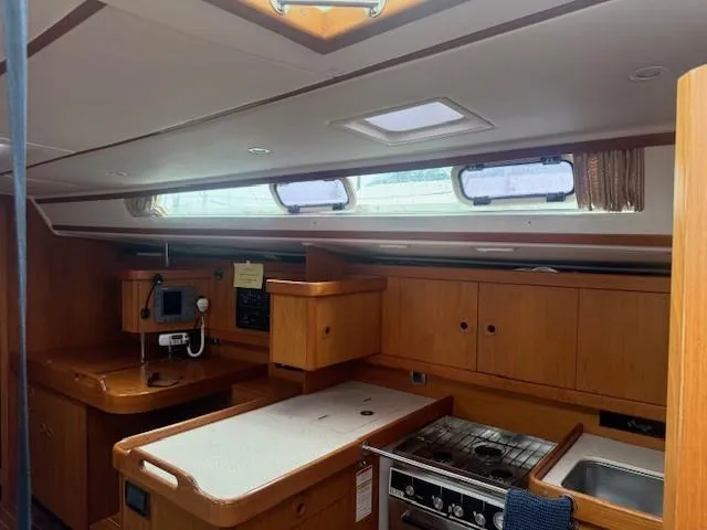 Slide: The Image of Interior of 2003 Wauquiez Centurion 45s yacht, featuring a well-equipped kitchen area. - 48