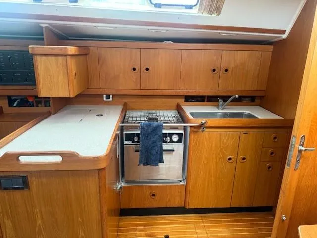 Slide: The Image of Interior of 2003 Wauquiez Centurion 45s yacht kitchen with wooden cabinetry and stainless steel appliances. - 49