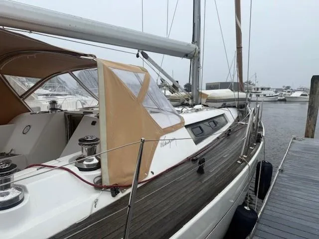Slide: The Image of Sailboat docked, 2003 Wauquiez Centurion 45s, featuring teak deck and beige canopy. - 8