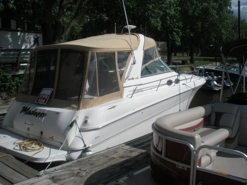 Slide: The Image of 2000 Sea Ray Sundancer 310 at dock, featuring canopy. - 13