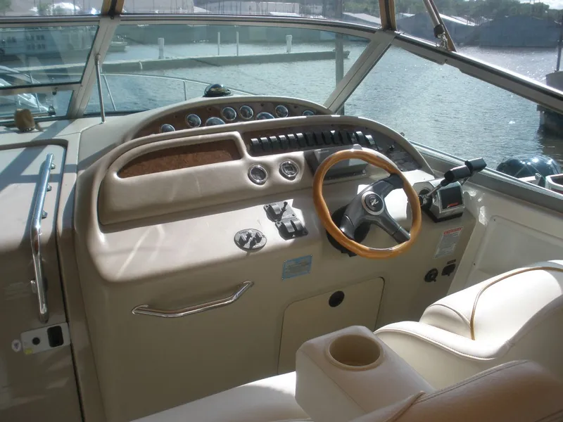 Slide: The Image of Cockpit of 2000 Sea Ray Sundancer 310 with wooden steering wheel. - 14