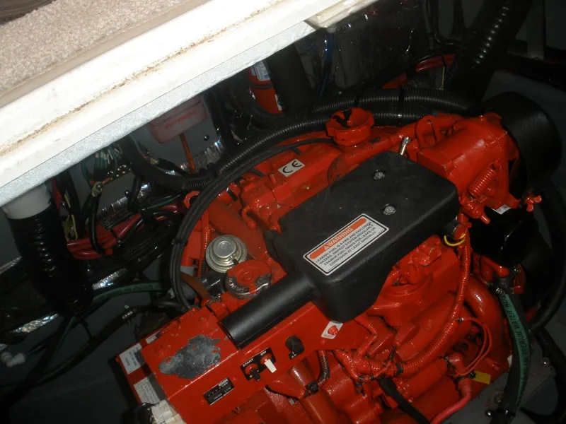 Slide: The Image of Engine compartment of 2000 Sea Ray Sundancer 310, featuring red engine. - 20