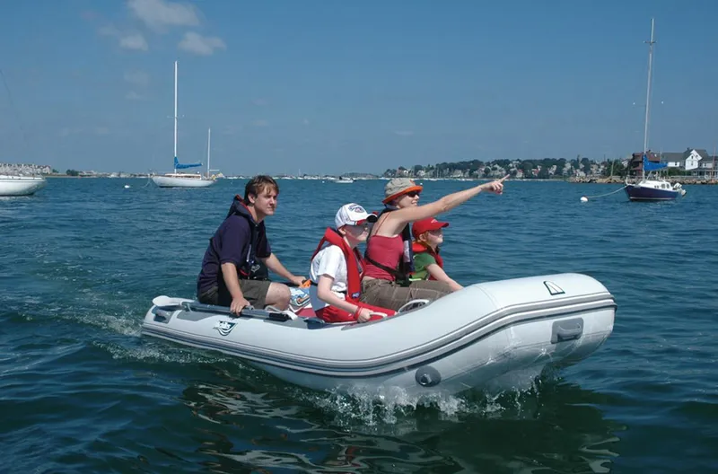 Slide: The Image of Family enjoying a ride on a 2024 Achilles HB-280DX inflatable boat. - 3
