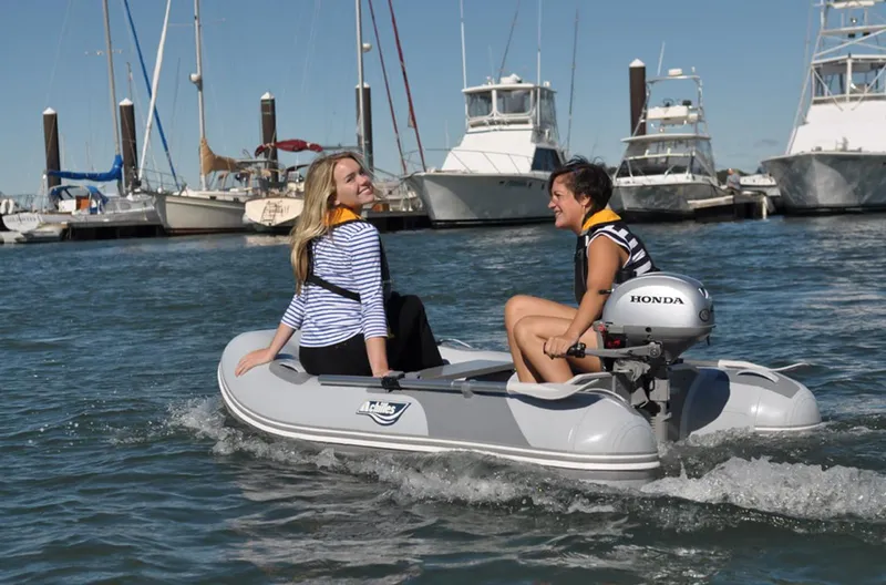 Slide: The Image of Two women enjoying a ride on a 2024 Achilles LSI-260E inflatable boat. - 3