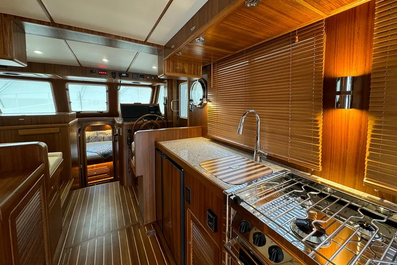 Slide: The Image of Luxurious interior of 2026 Helmsman Trawlers 38 Sedan with wood finishes and modern amenities. - 10