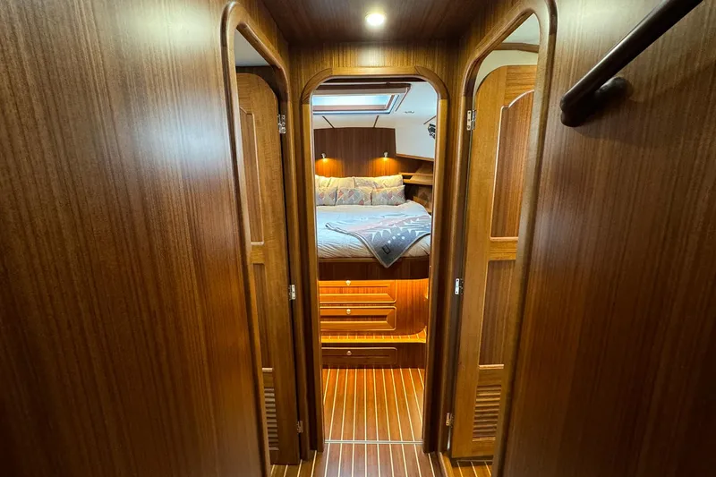 Slide: The Image of Luxurious cabin interior of 2026 Helmsman Trawlers 38 Sedan with wood finish and cozy bedding. - 15