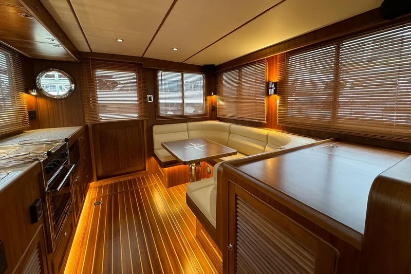 Slide: The Image of Luxurious interior of 2026 Helmsman Trawlers 38 Sedan with wood finishes and cozy seating. - 26