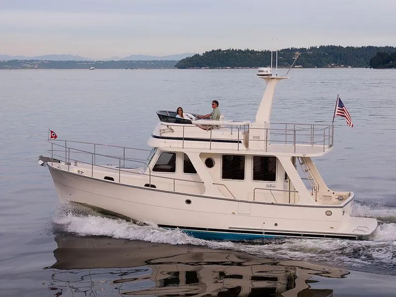 Slide: The Image of 2026 Helmsman Trawlers 38 Sedan cruising on calm waters with passengers onboard. - 30