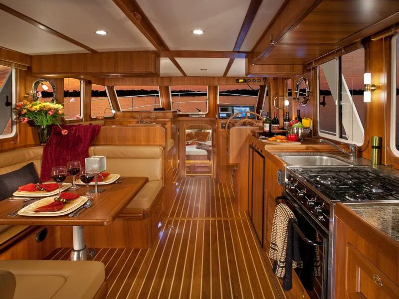 Slide: The Image of Luxurious interior of 2026 Helmsman Trawlers 38 Sedan with elegant dining and kitchen area. - 32