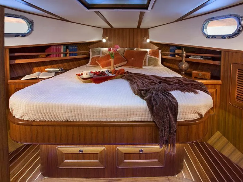 Slide: The Image of Luxurious cabin interior of 2026 Helmsman Trawlers 38 Sedan with cozy bed and elegant wood finish. - 36