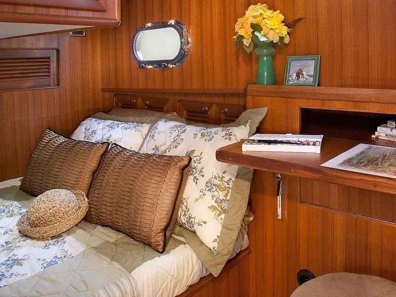 Slide: The Image of Cozy cabin interior of 2026 Helmsman Trawlers 38 Sedan with floral bedding and wooden accents. - 37