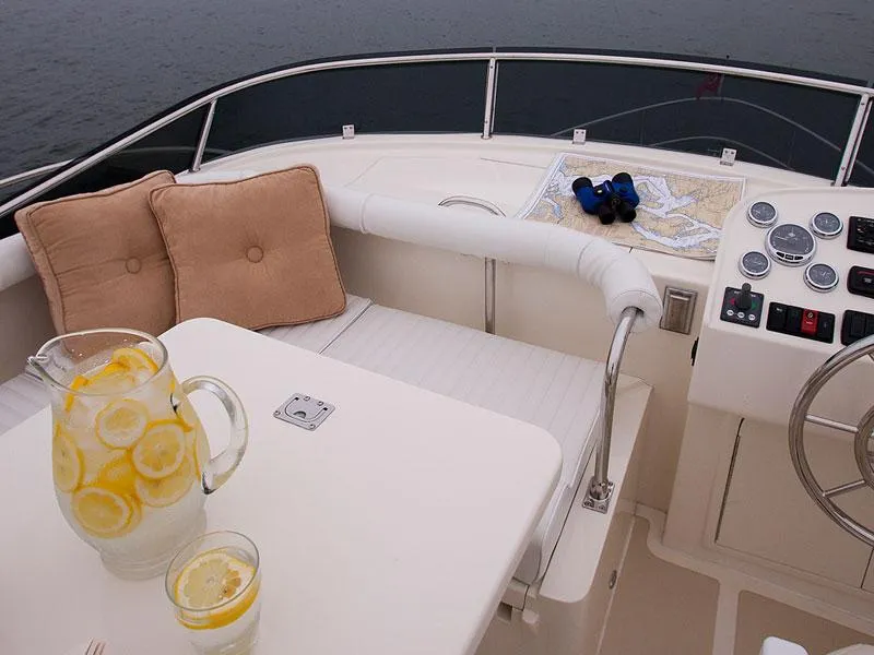 Slide: The Image of Helmsman Trawlers 38 Sedan 2026 yacht interior with lemonade, map, and binoculars on deck. - 42